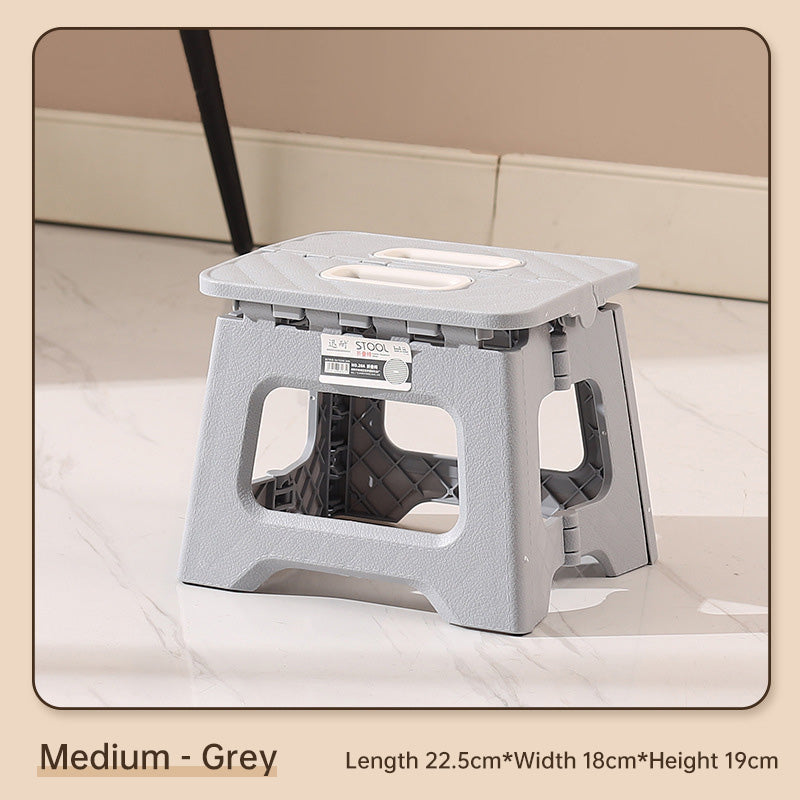 Person sitting on the folding stool