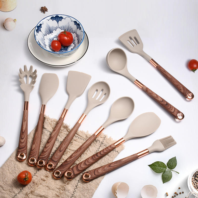 Silicone utensils with wooden handles in a holder