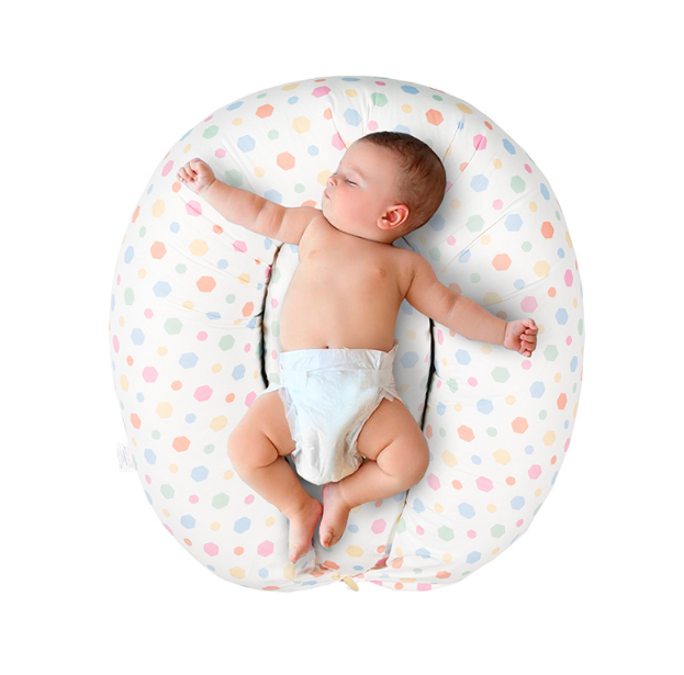 Baby supported on the nursing pillow
