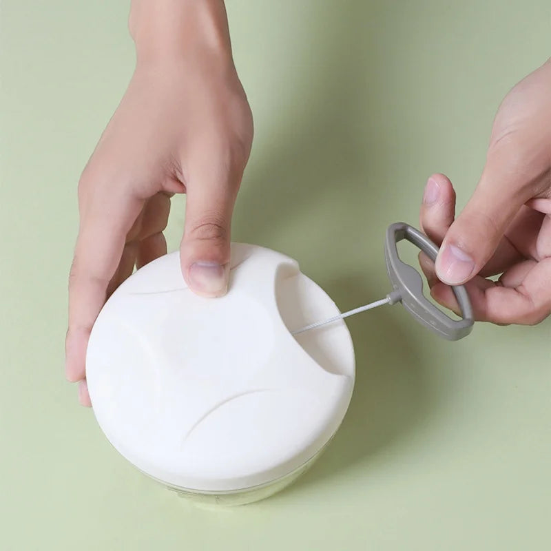 Pull-string chopper open showing stainless steel blades