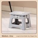 Person sitting on the folding stool