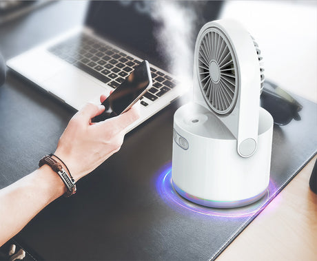 Misting fan releasing a cooling spray