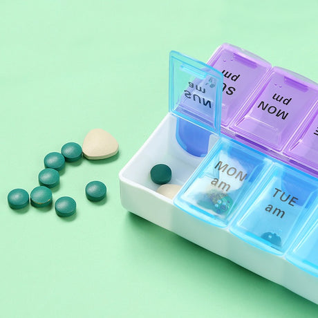 Pill organiser with AM and PM compartments open