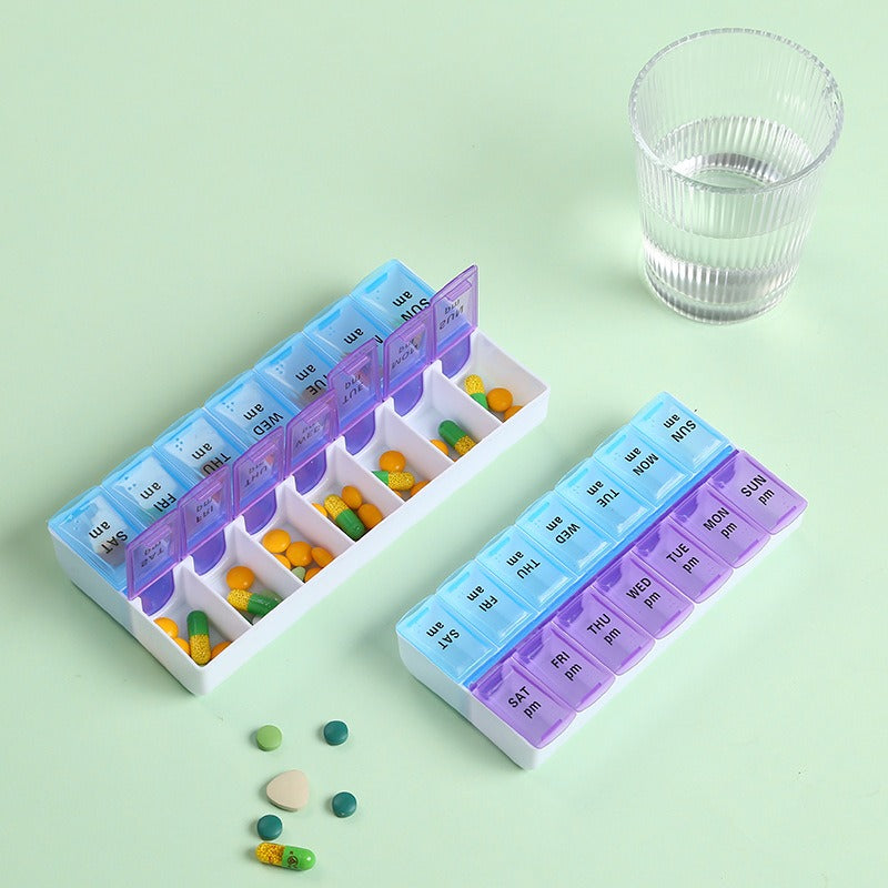 Slim pill organiser held in hand