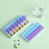 Slim pill organiser held in hand