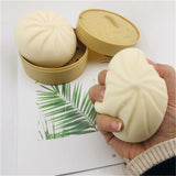 Hand squishing the steamed bun stress toy